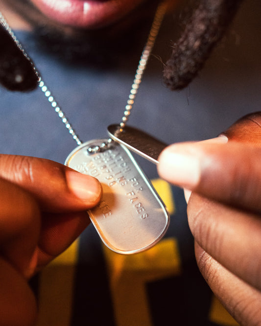 WFSF AWOL dog tag held, engraving detail